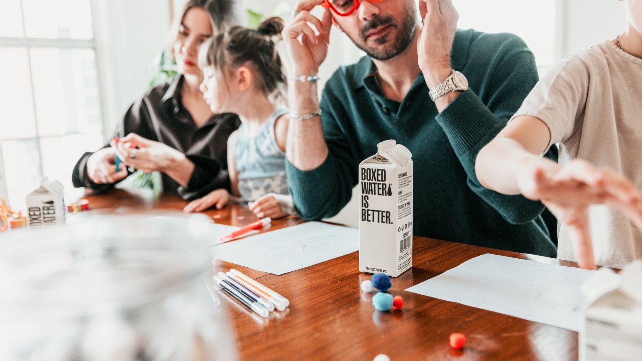 Blog image: A family playing crafts at the table.
