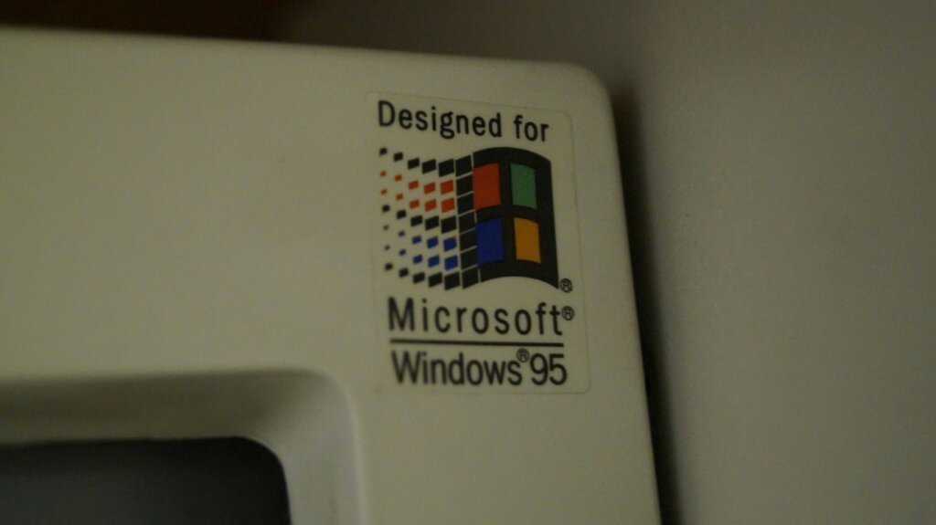 Closeup of the corner of a CRT monitor proudly displaying the Windows logo saying "Designed for Windows 95".